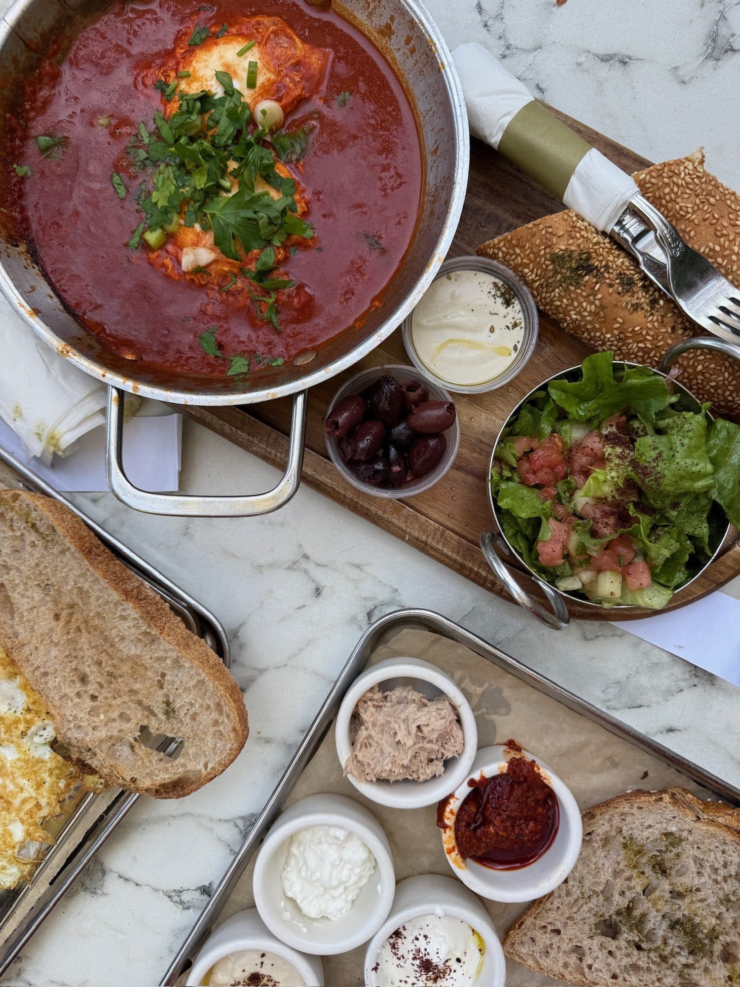 Shakshuka brunch spread with bread and dips