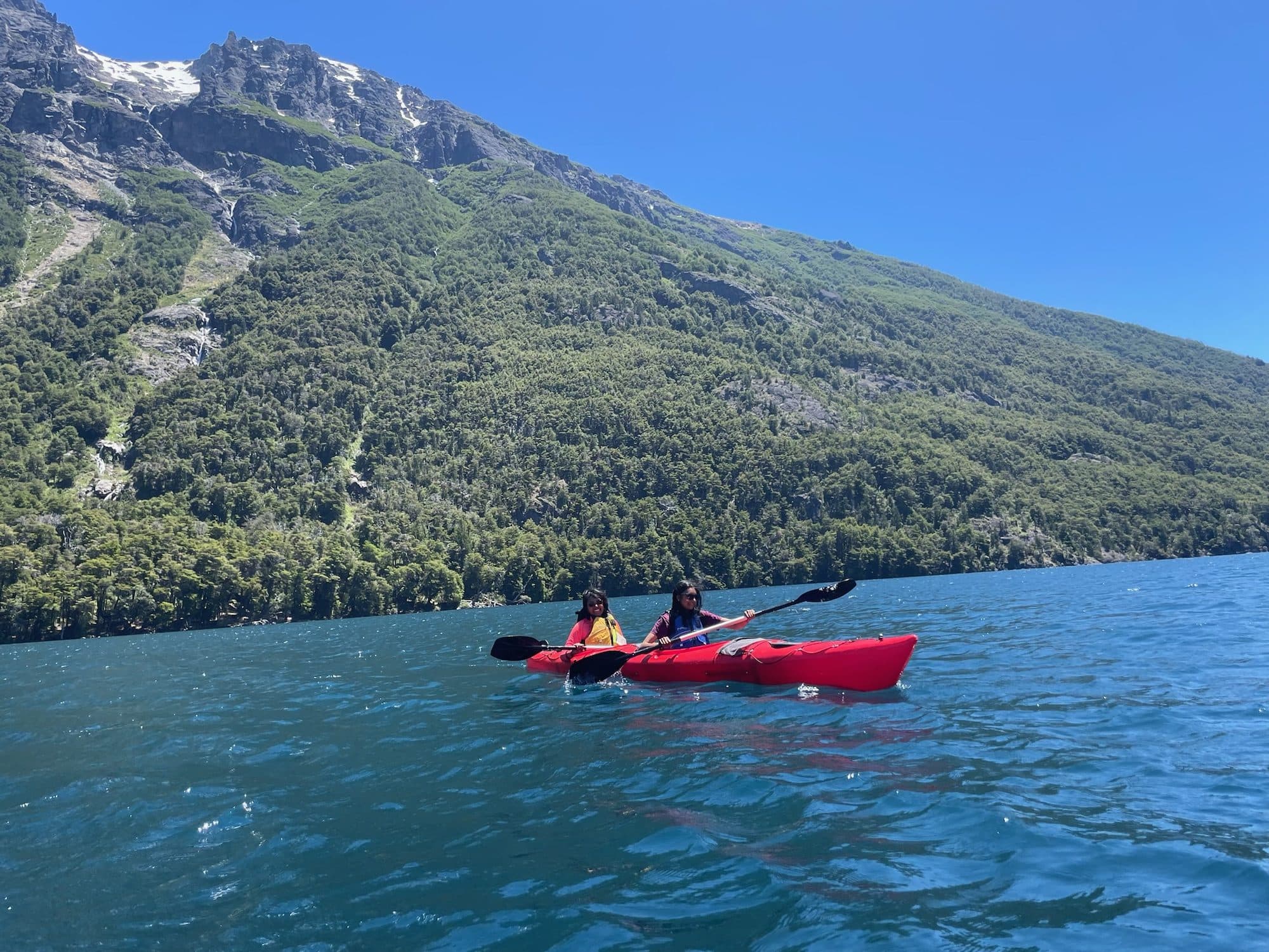 Kayaking on a glacial lake below mountains