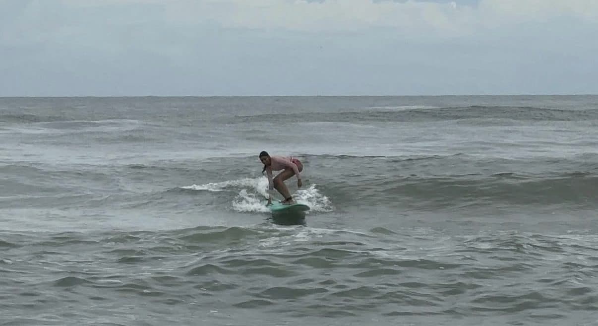 Aanya surfing a wave
